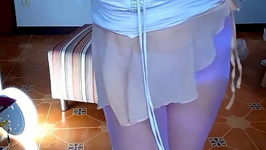 The ballerina takes off her clothes. The undressed ballerina